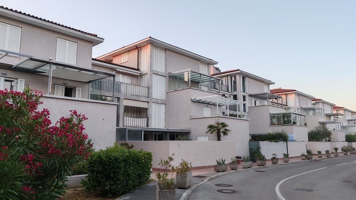 Contemporary apartment complex with outdoor greenery during twilight.